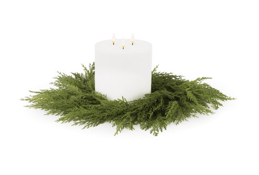 White triple-wick pillar candle centered in an 18-inch green cedar ring