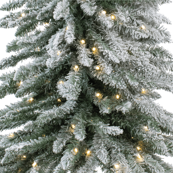 Flocked alpine artificial Christmas tree with warm white LED lights and snow dusting
