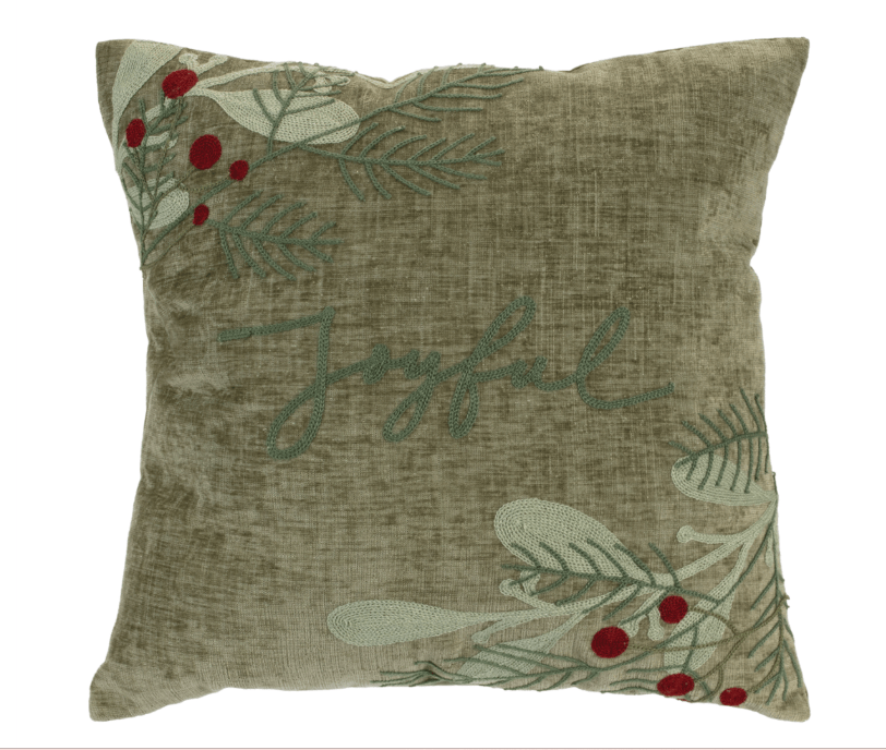 Sage green velvet throw pillow with embroidered Joyful script, holly berries, and pine branches