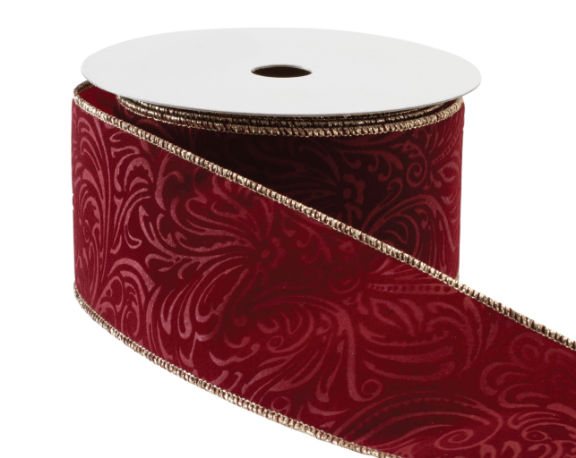 Crimson velvet wired ribbon with embossed floral pattern and gold edges on spool