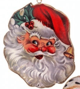 Vintage-style metal Santa face ornament with rosy cheeks, white beard, and red hat