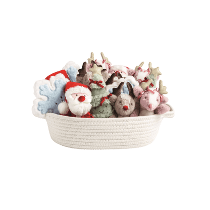 Assorted mini Christmas plush toys in a woven rope basket, featuring Santa, reindeer, and holiday characters