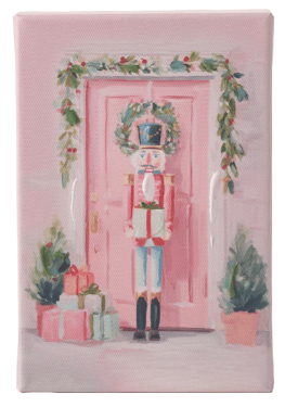 Pink holiday canvas art featuring nutcracker, wreath-adorned door, gifts, and topiaries