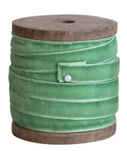 Green velvet ribbon wound on a round wooden spool, 10 yards