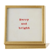 Gold metal square frame with glass front displaying red Merry and Bright text
