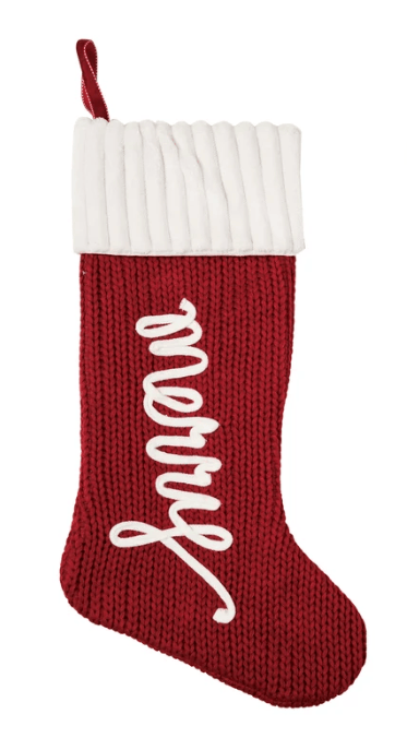 Red knit Christmas stocking with white ribbed cuff and cursive Merry script