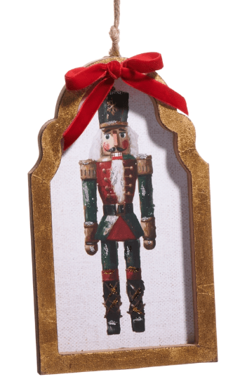 Wooden framed ornament with nutcracker print, gold trim, red velvet bow, rope hanger