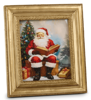 Gold framed mini wall art print of Santa Claus reading beside a Christmas tree