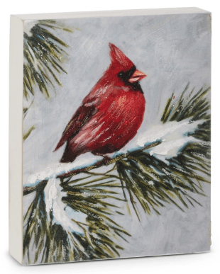 Painted canvas block art of red cardinal perched on snow-covered pine branch