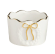 White ceramic tidbit dish with scalloped edges, gold trim, and bow accent