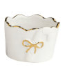 White ceramic tidbit dish with gold rim and embossed bow detail