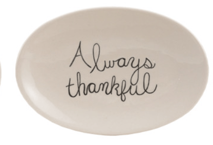 Oval white stoneware plate with black cursive text reading Always Thankful