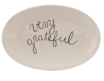 White oval stoneware plate with black cursive 'very grateful' script lettering