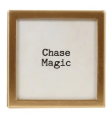 Gold-framed glass magnet with black text reading Chase Magic