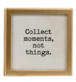Gold-framed glass magnet with black text reading Collect moments not things