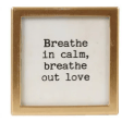 Gold-framed glass magnet with black text reading Breathe in calm, breathe out love