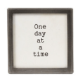 Small square metal and glass framed magnet with black text One Day At A Time