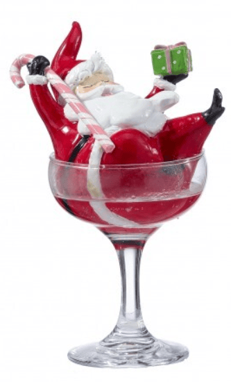 Resin Santa Claus figurine relaxing in red cocktail glass holding candy cane and gift