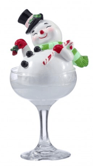 Resin snowman figurine sitting in clear champagne glass with candy cane and holly accents