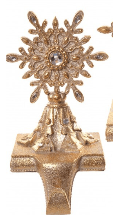 Gold resin snowflake Christmas stocking holder with jeweled accents on mantel bracket