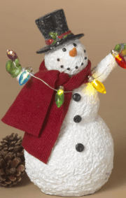 Resin snowman holding colorful string lights wearing red scarf and black top hat
