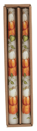 Two white taper candles with orange pumpkin and green vine pattern in kraft box