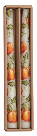 Two white taper candles with orange pumpkin and green vine pattern in kraft box