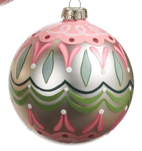 Pink and green glass ball ornament with floral scallop pattern and white dot details