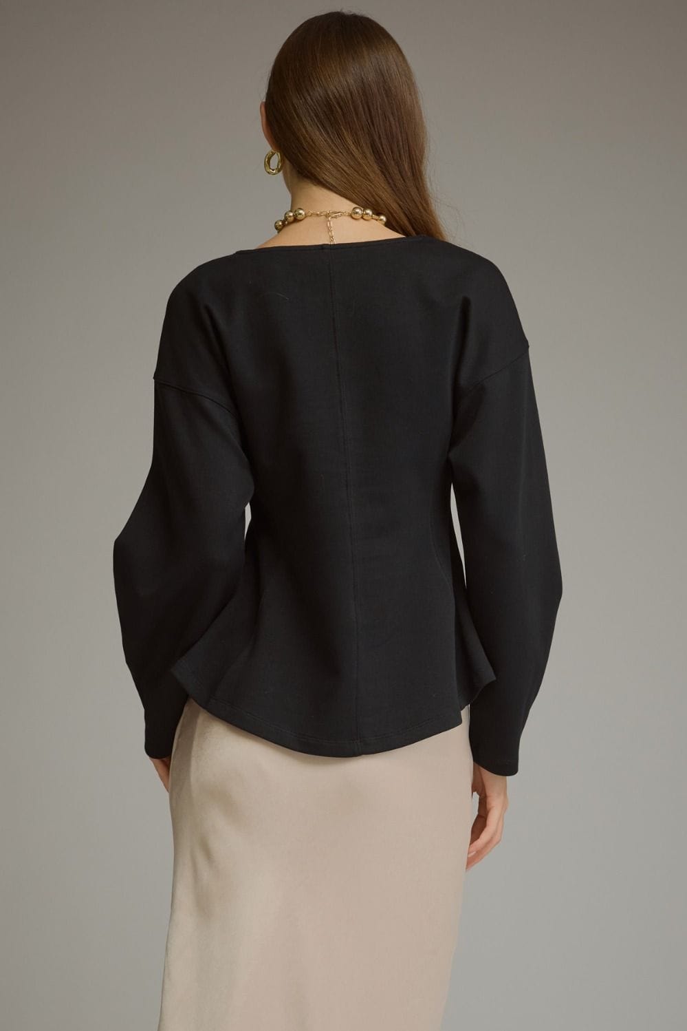 Entro black curved seam long sleeve top with balloon sleeves, back view