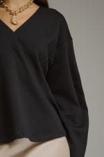 Entro black long sleeve V-neck top with curved hem and relaxed fit