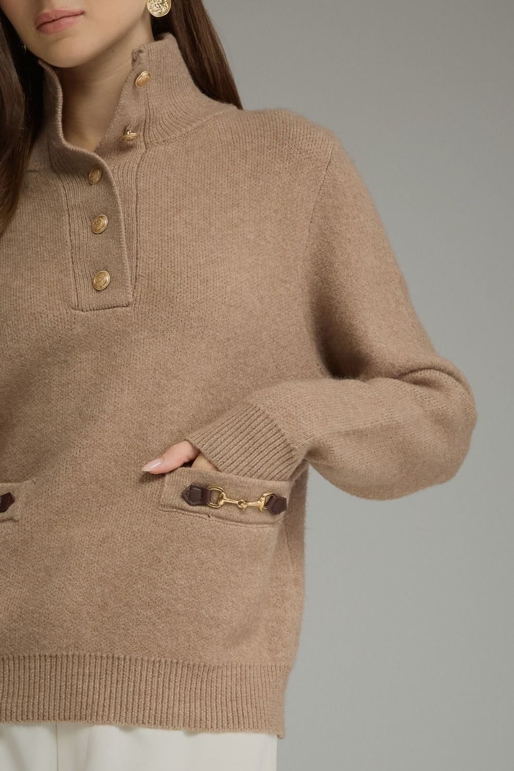 Camel knit sweater with gold buttons, mock neck, and horsebit pocket detail
