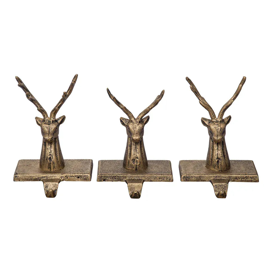 Set of three antique gold cast iron reindeer head Christmas stocking holders with hooks