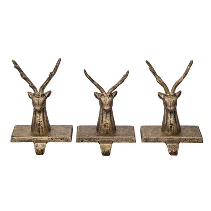 Set of three antique gold cast iron reindeer head Christmas stocking holders with hooks