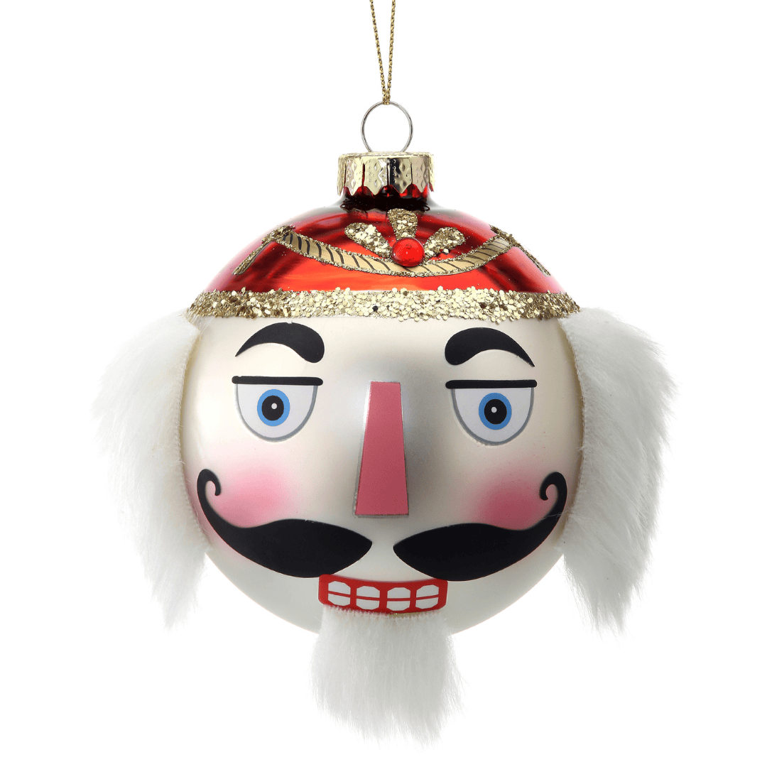 Glass ball ornament shaped as a nutcracker face with red hat, white fur accents, and gold glitter trim