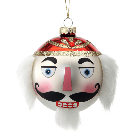 Glass ball ornament shaped as a nutcracker face with red hat, white fur accents, and gold glitter trim