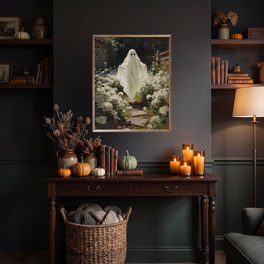 Framed ghost garden painting displayed above a dark wood console table with fall decor