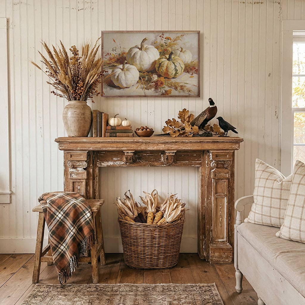 Framed autumn pumpkin still life painting in white and green tones displayed on wall