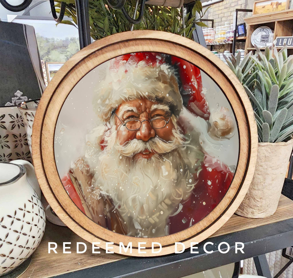 Round wood-framed canvas Santa Claus portrait with snowy white beard and red hat