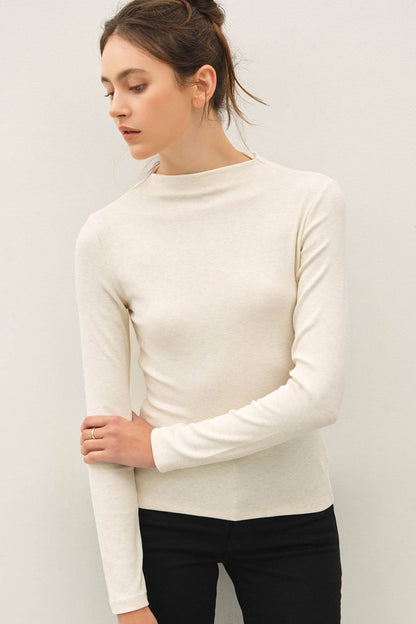 Women's ivory ribbed mockneck long sleeve slim fit knit top with black pants
