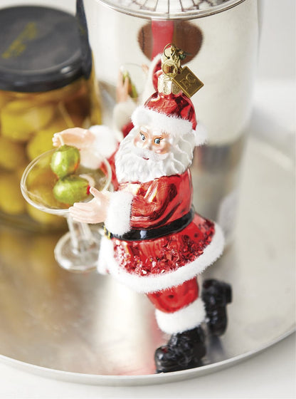 Santa Claus glass ornament holding a martini glass with green olives, festive red suit