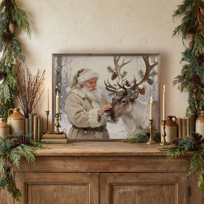 Framed Santa and reindeer wall art on rustic wood sideboard with candles and greenery