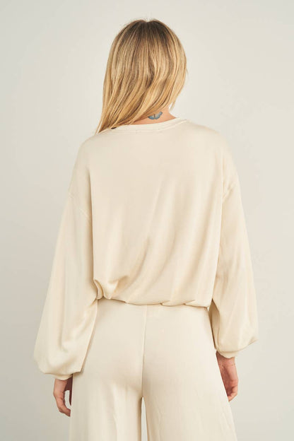 ANWND cream cropped crewneck sweatshirt with balloon sleeves, back view