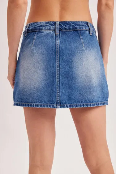 Women's low-rise medium wash blue denim mini skort, back view