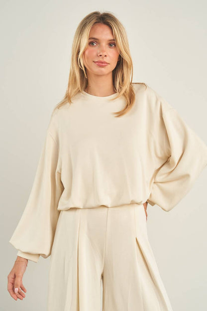Cream cropped crewneck sweatshirt with oversized balloon sleeves and banded hem