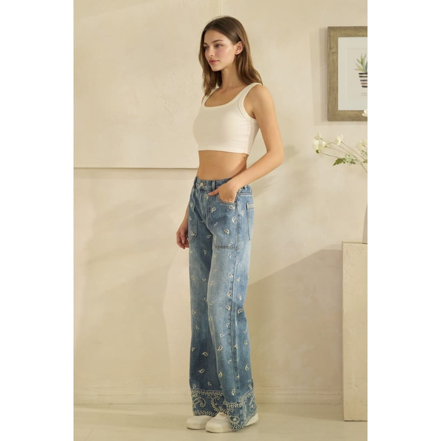 Wide-leg paisley print medium wash denim jeans with embroidered hem detail