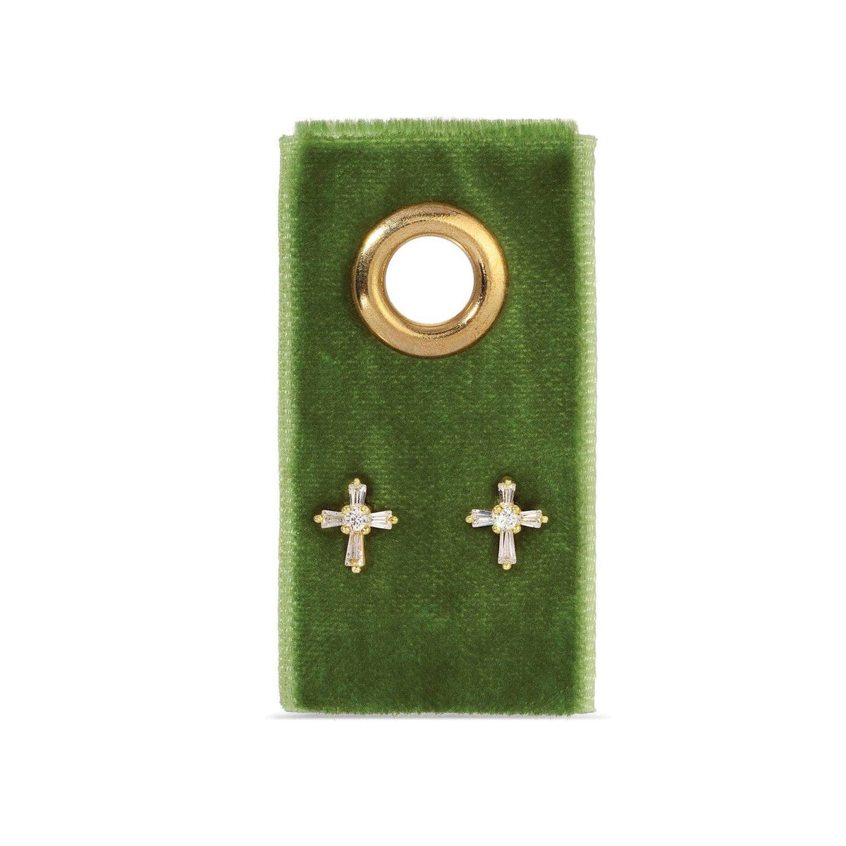 Gold baguette cubic zirconia cross stud earrings displayed on green velvet gift tag