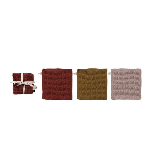 Set of three knit cotton dish cloths in rust, olive, and blush with basket-weave texture