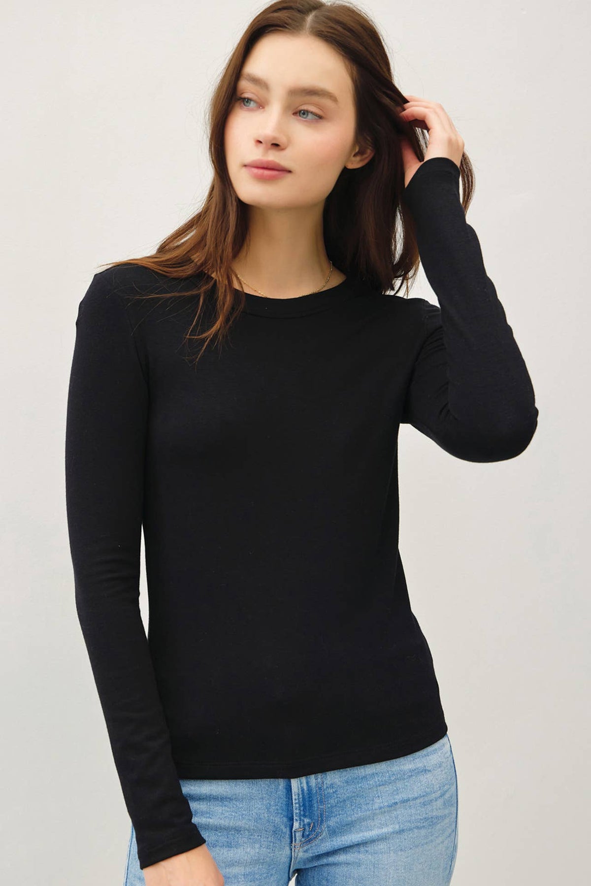 Be Cool black round neck long sleeve fitted knit top with blue jeans