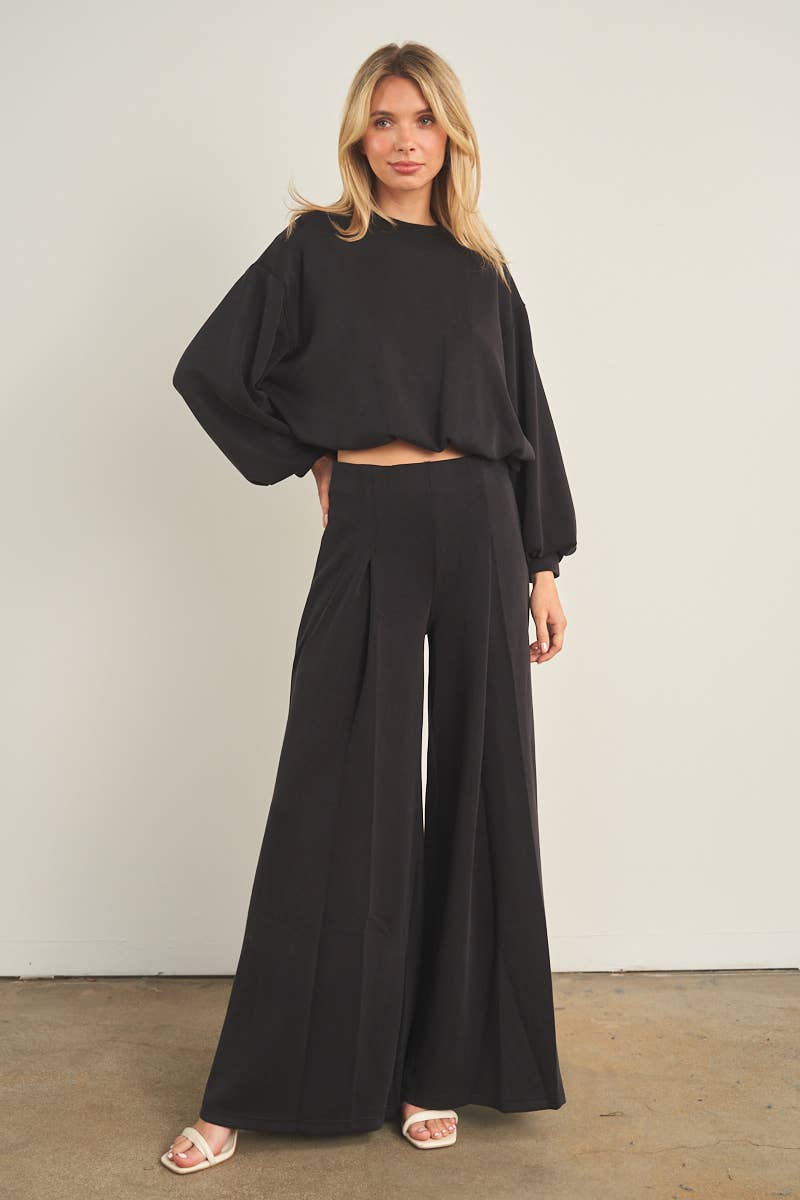 Black wide-leg palazzo pants with high waist and pleated front detail
