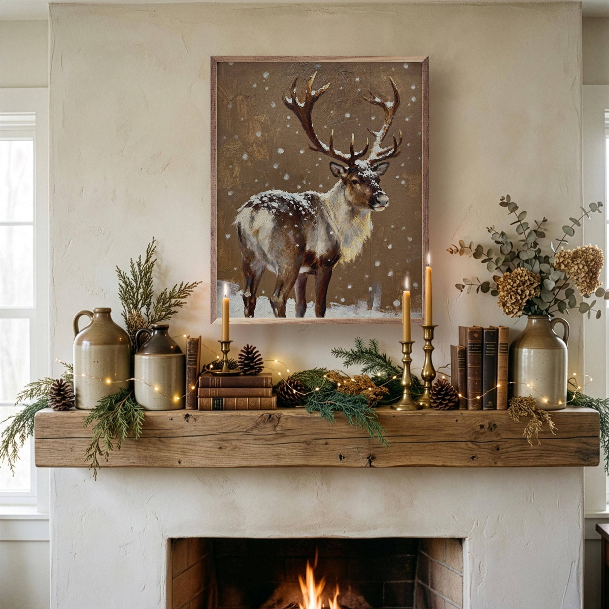 Framed reindeer painting in snow above rustic wood fireplace mantel with candles